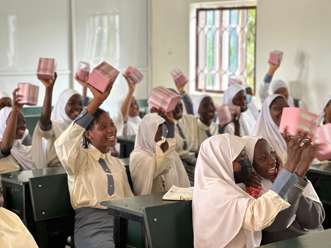 Students celebrating with pad boxes in a classroom
